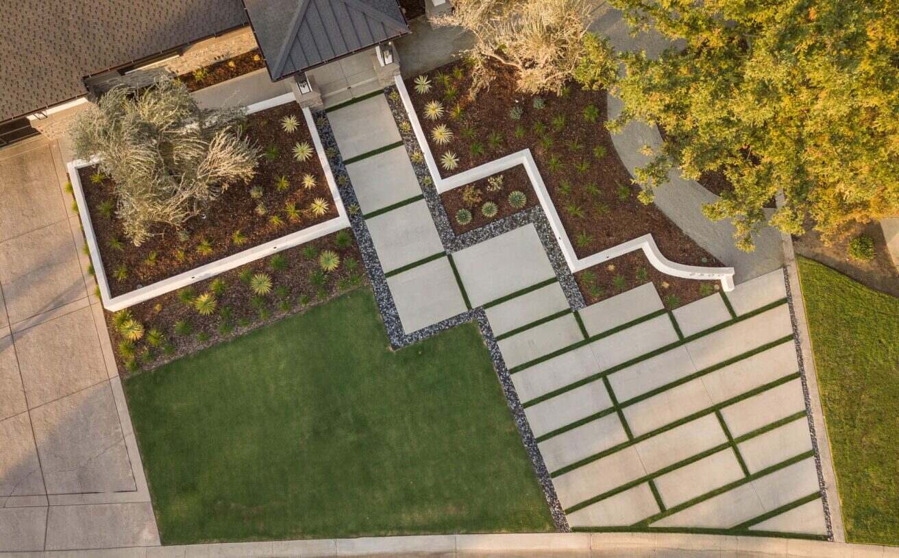 Aerial view of a landscaped yard with pathways and greenery