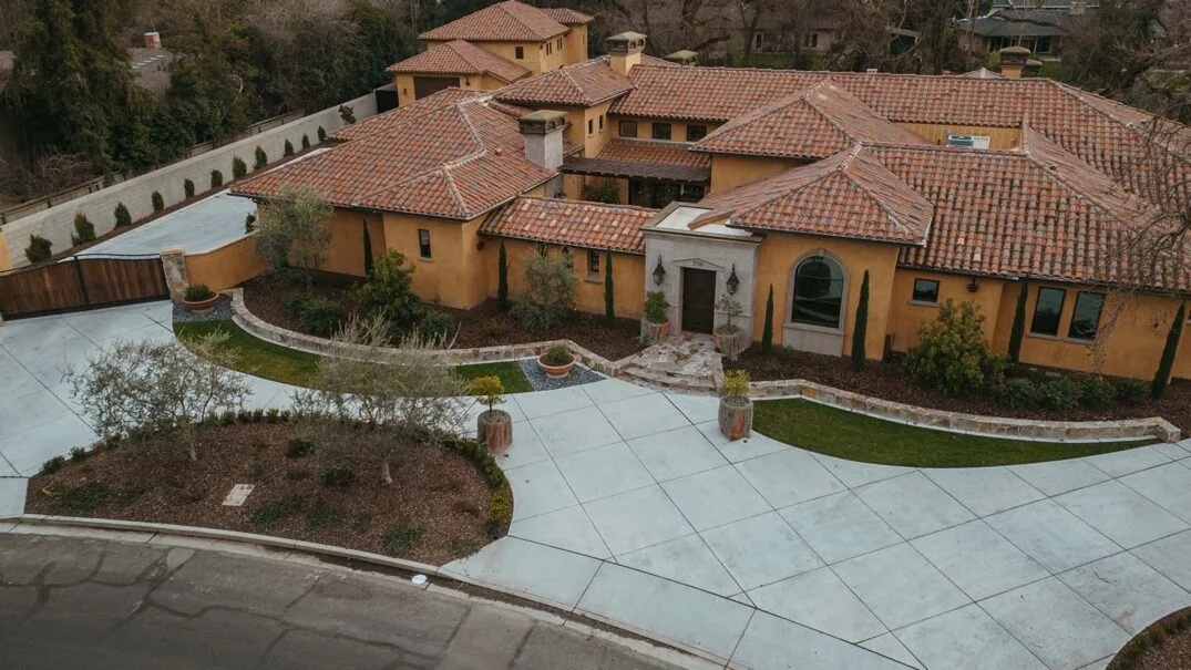 Aerial view of a large house with a tiled roof