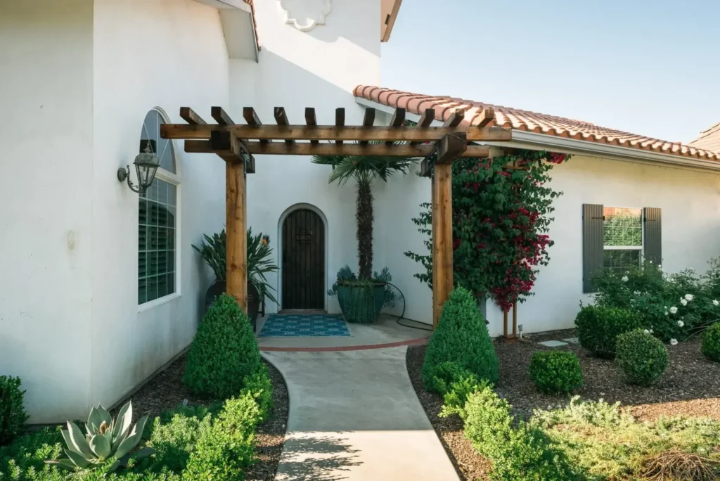 Entrance of a Spanish-style residence with landscaping