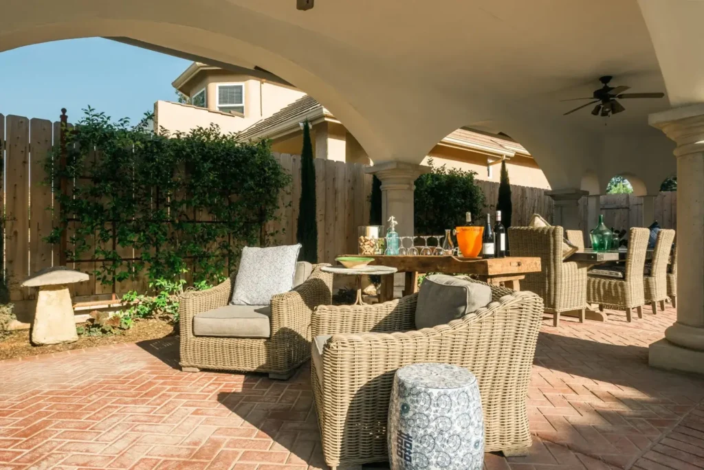 Outdoor seating area with wicker furniture and dining table