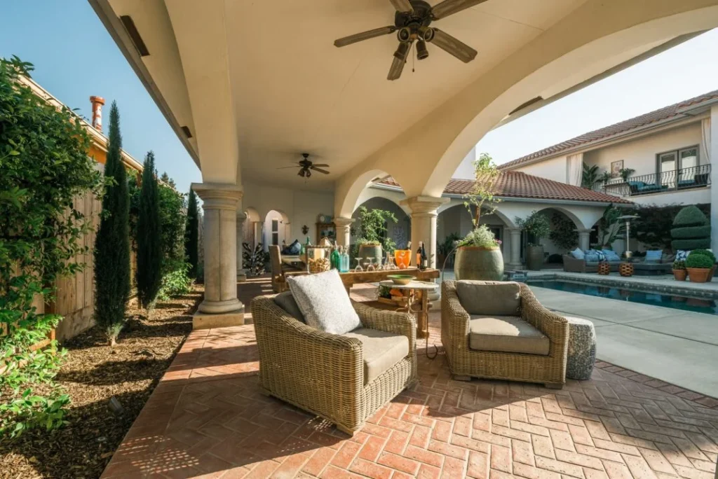 Outdoor seating area by the pool in a Spanish-style residence
