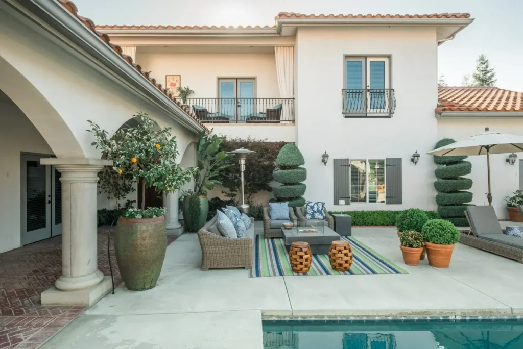 Traditional patio with seating and plants at a residence